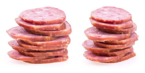 Slices of salami sausages isolated on a white background.