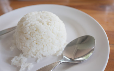 cooked rice fork and spoon in white dish