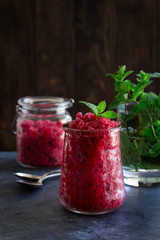 Frozen raspberry granita with mint in glass jars