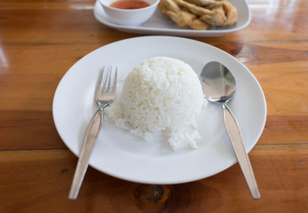 cooked rice fork and spoon in white dish