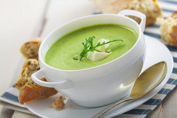 Traditional cream soup made of spinach on a table. Classic European food.