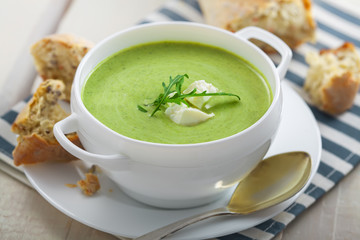 Cream soup made of broccoli on table. Traditional European food.