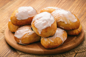 Sweet yeast buns with blueberries  on brown wooden table. 