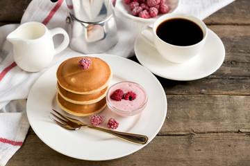 Pancake with raspberry and cup of coffee 