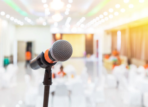 Close up microphone in meeting hall or seminar room background