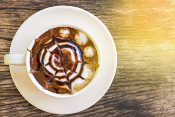 top view hot caramel coffee on wooden table  in the morning