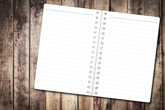 Open notebook paper with line on wood background for design with copy space for text or image.