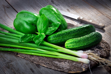 Fresh green vegetables on wooden background
