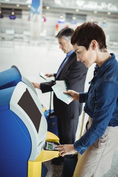 Business People Using Self Service Check-in Machine