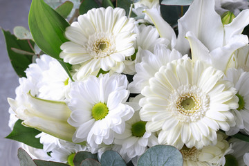 Floral background with white gerbera flowers, chrysanthemums and