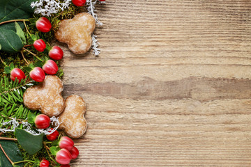 Christmas background with moss, hypericum and gingerbread cookie