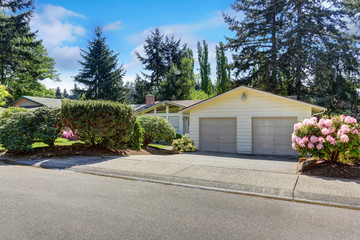 Naklejka premium American one level house exterior double garage and driveway.