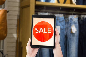 Shopping woman using a tablet in the modern mobile world online.