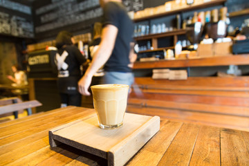 Hot latte coffee cup on the wooden table