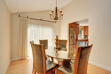 Dining room interior with table set. Glass table and leather chairs.