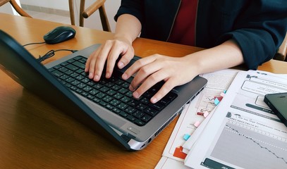 Young working age working and surfing the internet by using a laptop