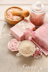 Spa set: Bowl of bath sea salt, bar of soap and soft pink towel.