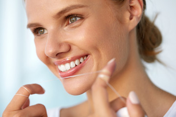 Dental Hygiene. Beautiful Woman Flossing Healthy White Teeth. High Resolution Image