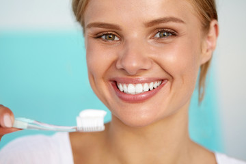 Beautiful Smiling Woman Brushing Healthy White Teeth With Brush. High Resolution Image