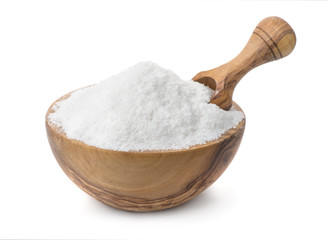 Wood bowl full of cooking salt with scoop