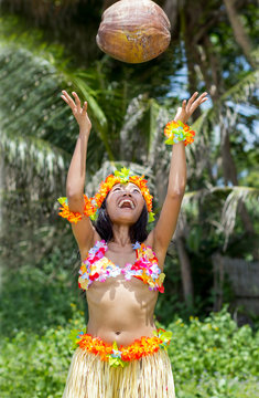 Cheerful hawaii hula dancer throw with coconut at tropical jungle