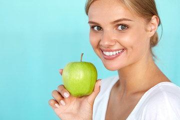 Woman With Apple. Beautiful Girl With White Smile, Healthy Teeth. High Resolution Image