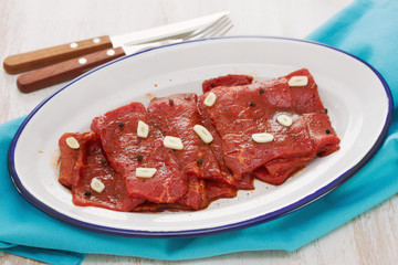 meat with sauce and garlic on white dish