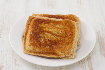 sandwiches on white plate on white wooden background