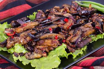 Baked eggplant with onions, garlic, red hot chili pepper and walnuts