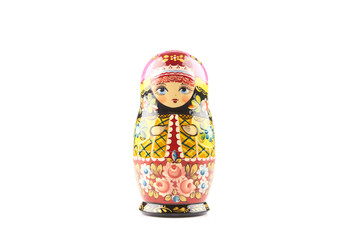 Wooden matryoshka doll painted in russian traditional style ornaments on white isolated background