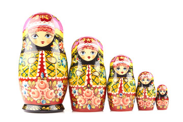 Five wooden matryoshka dolls painted in russian traditional style ornaments on white isolated background