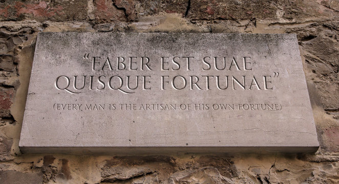 Faber est suae quisque fortunae. A Latin phrase meaning Every man is the artisan of his own fortune. Engraved text.