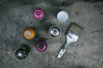 Street art equipment, spray cans and brush
