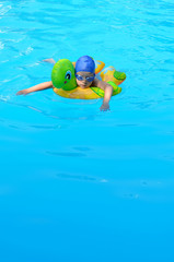 Little girl swimming in the pool wearing glasses for smooth, spa