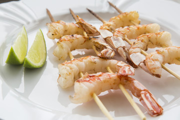 Fried shrimp with lemon on a white plate oven old wooden backgro