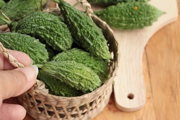 Bitter melon and sliced on wood background.