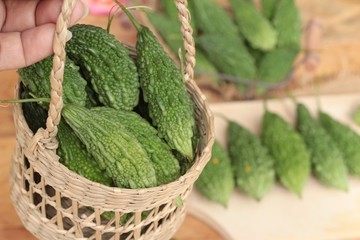Bitter melon and sliced on wood background.