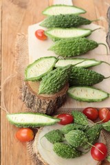 Bitter melon and sliced on wood background.