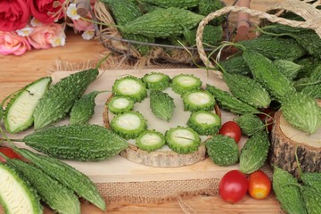Bitter melon and sliced on wood background.