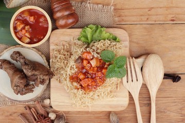 Chicken noodle with sauce tomato is delicious.