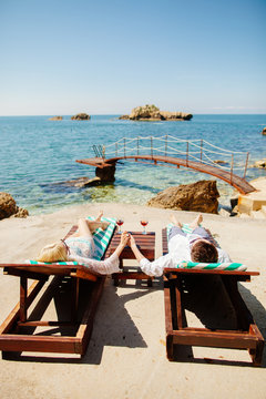 honeymoon couple relax on beach wth sea view