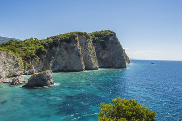 Naklejka premium Rocky steep coast of the island of St. Nikola from the Adriatic Sea, near Budva, Montenegro
