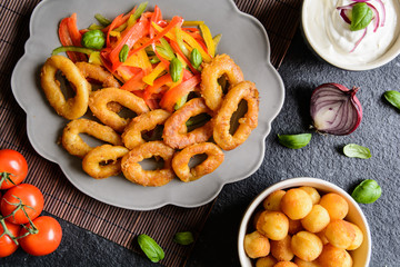 Batter fried squid rings with potato croquettes and pepper salad
