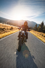Naklejka premium Motorcycle driver riding on motorway