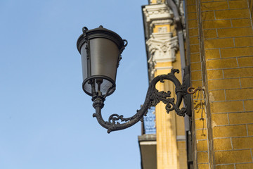 Ancient lantern on the wall of a building. Architecture