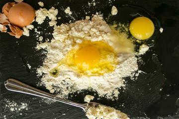 Ingredients for fresh cheesecakes - eggs and flour