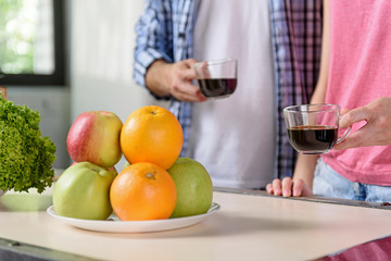 Cheerful man and woman enjoying drink together