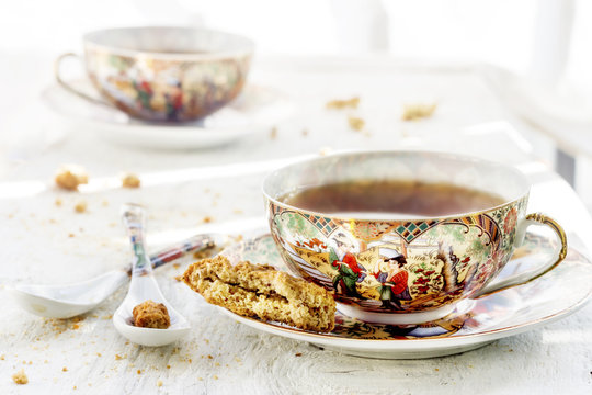 Two iapan's stily cups of tea with cookie