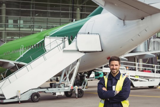 Portrait of airport ground crew standing on runway