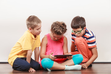 Fototapeta premium Kids playing on tablet.